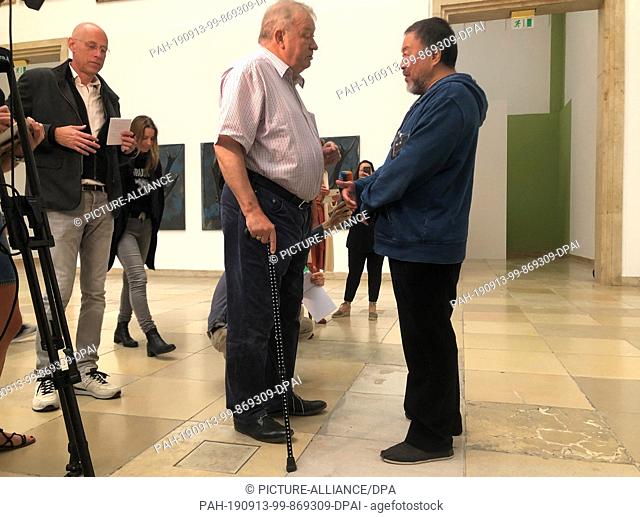 HANDOUT - 13 September 2019, Bavaria, Munich: Ai Weiwei (r), artist from China, talks at the Haus der Kunst with Bernhard Spies, managing director of the museum