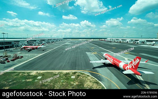 KUALA LUMPUR, MALAYSIA - NOVEMBER 05, 2015: Airplane of Air Asia airline and other planes on flying line in Kuala Lumpur airport