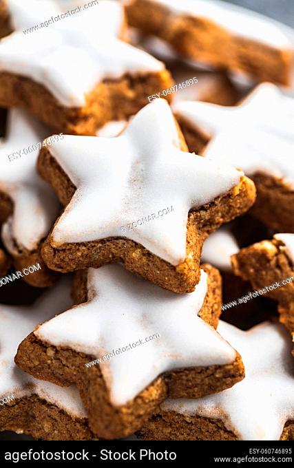 Icing gingerbread stars. Traditional Christmas cookies