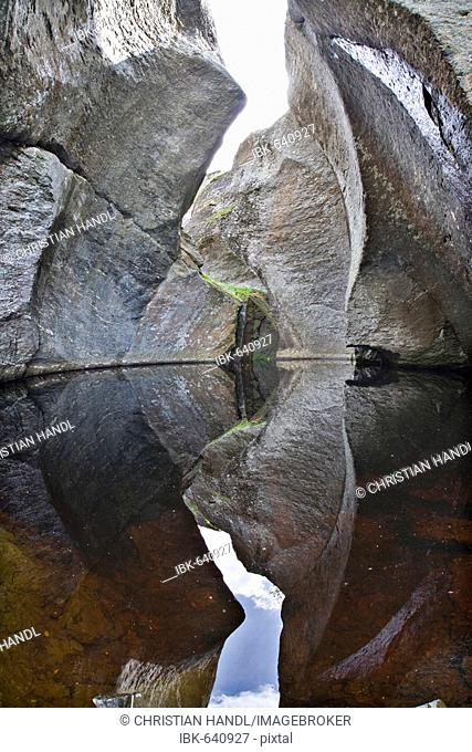 Rocks reflected in a pond in Vetlahelvete Cave, Aurlandsdalen Valley, Norway, Scandinavia, Europe
