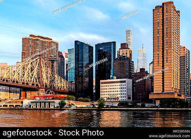 New York City / USA - JUL 31 2018: Queensboro Bridge and midtown view from Roosevelt Island at sunrise