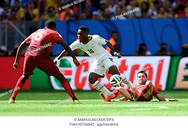 Andre Ayew (C) of Ghana in action against Ruben Amorim (R) and William of Portugal during the FIFA World Cup 2014 group G preliminary round match between...