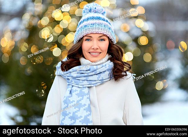 happy woman walking in christmas city in winter