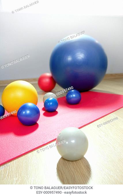 balls stability and toning pilates sport gym on red yoga mat