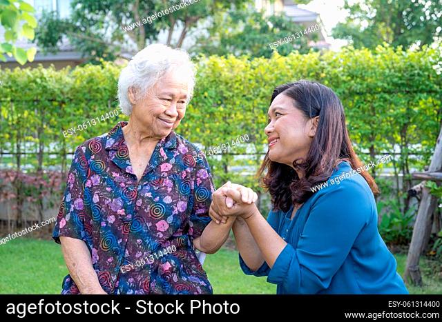 Asian elderly woman with caregiver enjoy and happy in nature park