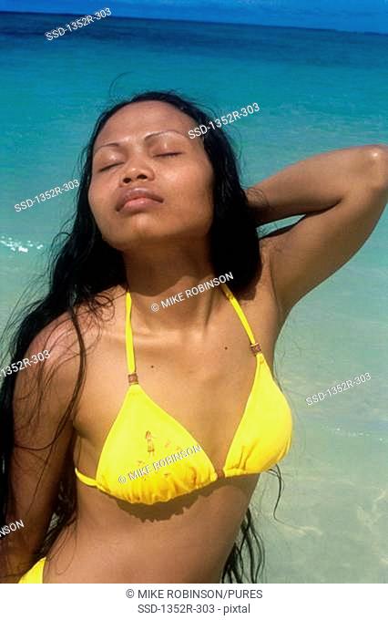Young woman on the beach, Lanikai Beach, Oahu, Hawaii, USA