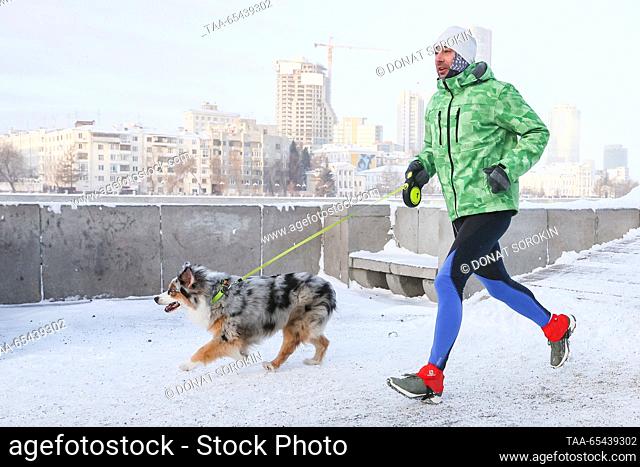 RUSSIA, YEKATERINBURG - DECEMBER 3, 2023: A man takes part in the Europe-Asia winter half marathon in a city embankment. Donat Sorokin/TASS