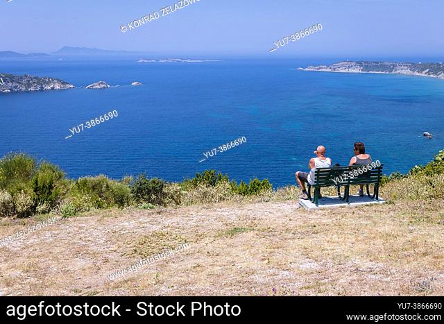 Benches on Ionian Sea viewing point in Afionas village on the Greek island of Corfu, view with Gravia and Varkoules islets
