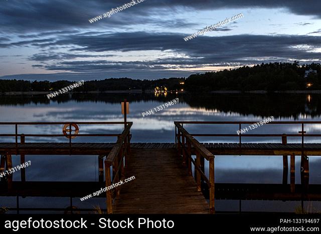 Stockholm, Sweden A midsummer midnight sun view over lake Malaren and a dock. | usage worldwide. - STOCKHOLM/Sweden