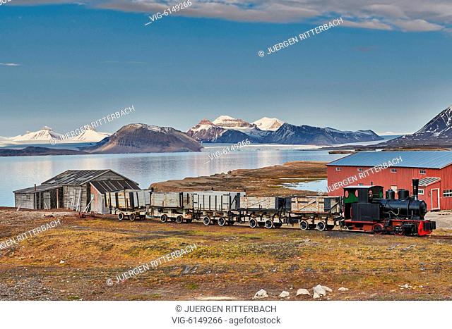 old coal train and view from the Northernmost civilian and functional settlement Ny-Ålesund on the landscape with the three crones, Svalbard or Spitsbergen