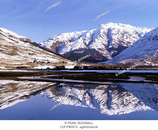 Scotland, Highland, Sheil Bridge, Reflections on Loch Duich looking towards Morvich and the Croe estuary from A87 bridge with snow on the mountains in winter