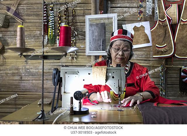 Bidayuh woman sewing at Sarawak Cultural Village also named as Sarawak Living Museum, Damai, Malaysia
