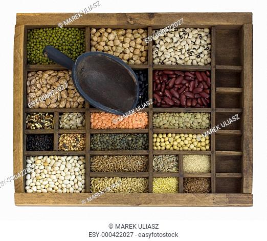 typesetter case with scoop and assorted beans, grains and seeds