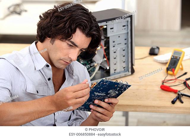 man repairing pc
