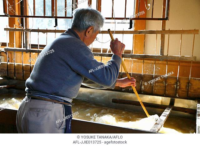Japanese traditional paper craftsman working in his studio