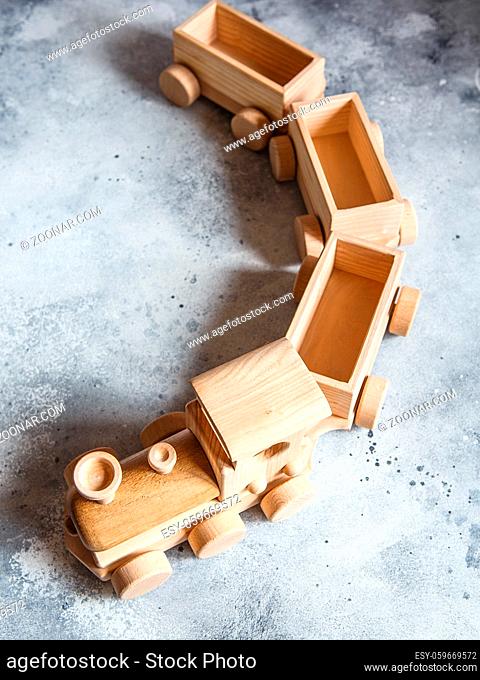 Children's wooden toys. Children wooden train with wagons. Natural wood construction set. Educational equipment. Children's wooden locomotive with various cargo...