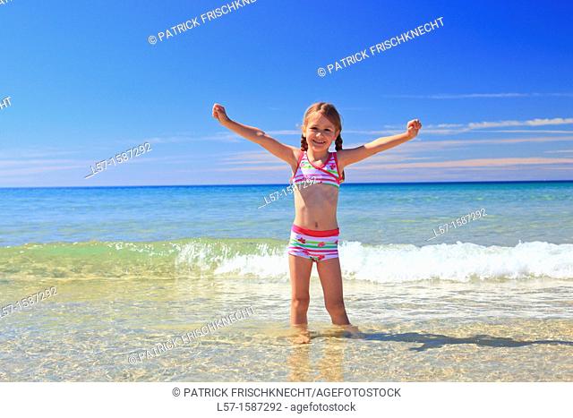girl playing on sandy beach, Sutherland, Scotland