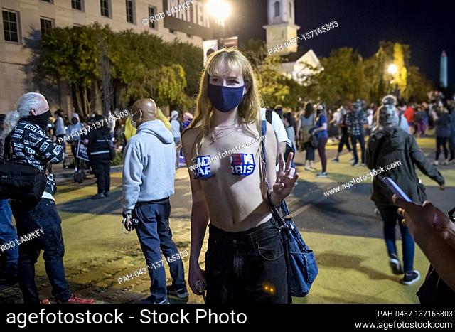 Lana Coulon, of Washington, DC, poses for photographers along Black Lives Matter Plaza as people celebrate and dance in the streets near the White House in the...