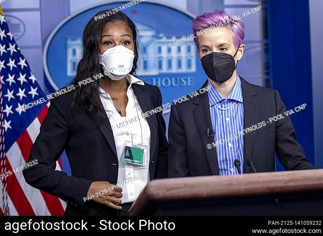 American professional soccer players Megan Rapinoe (R) and Margaret Purce (L) have their picture taken at the briefing room podium prior to the event to mark...