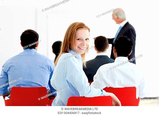 Smiling caucasian businesswoman at a conference