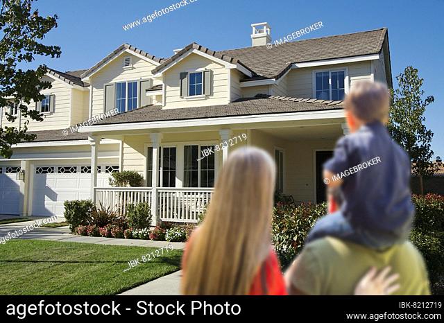 Young family looking at a beautiful new home