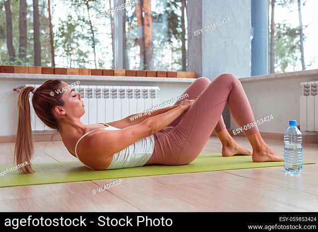 Young sporty woman doing abs exercise