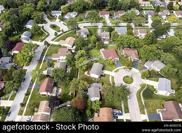 Aerial view of a tree-lined neighborhood in a cul-de-sac in a Chicago suburban city in summer