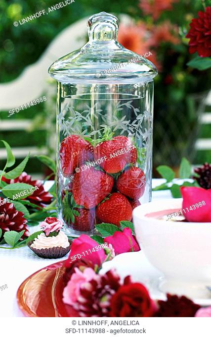 Fresh strawberries in a tall jar