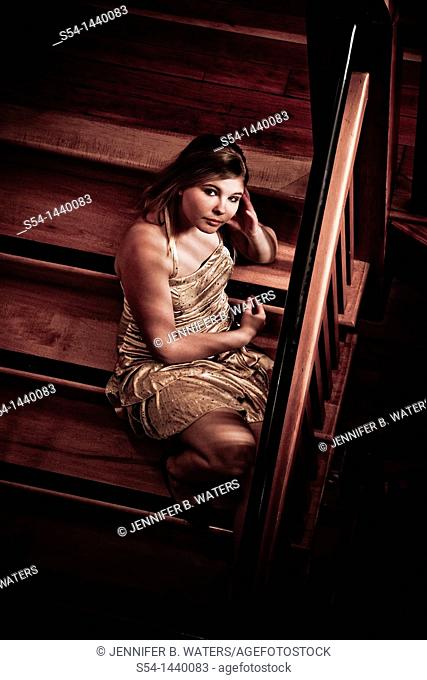 A teen girl sitting on a stairway