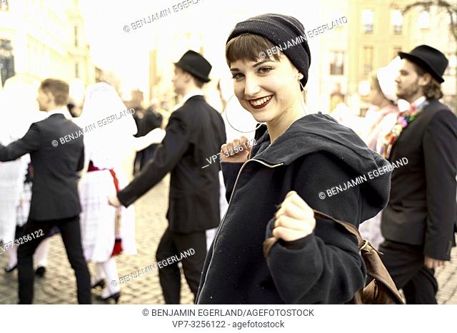 playful woman at German culture celebration in leisure clothes, at street in city Cottbus, Brandenburg, Germany
