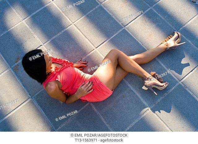 Lying on shadowed floor young woman