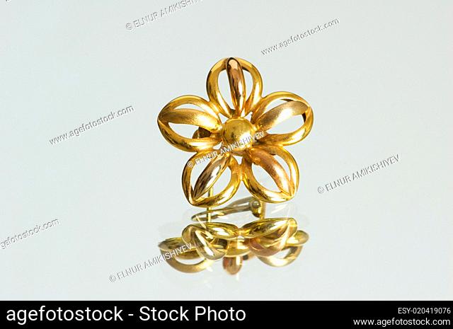 Flower shaped ring on the reflective background