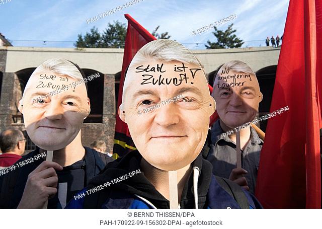 Employees of Thyssenkrupp wear masks of Heinrich Hiesinger, chairman of the management of Thyssenkrupp AG, during a protest organised by the worker's council...