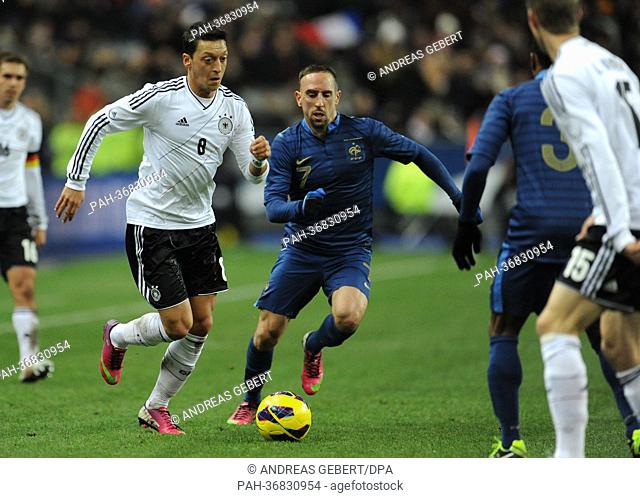 Germany's Mesut Oezil (L) and France's Franck Ribery fight for the ball during the international friendly soccer match France vs