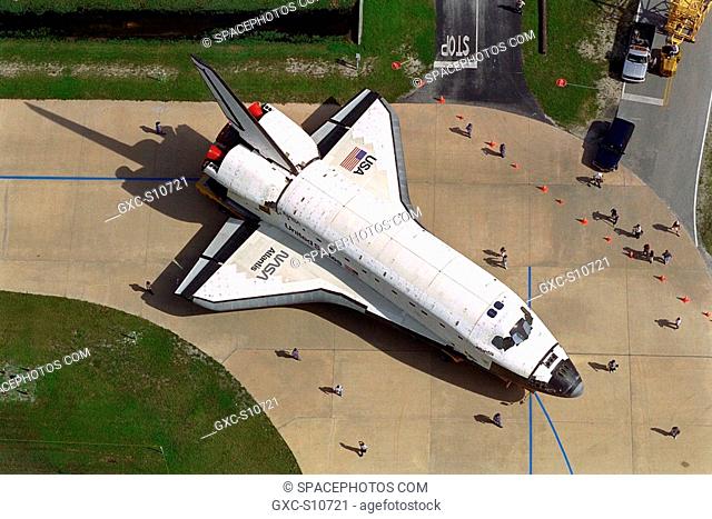 08/11/1997 --- Carried atop an orbiter transporter, the Space Shuttle orbiter Atlantis makes the short journey from Orbiter Processing Facility Bay 3 to the...