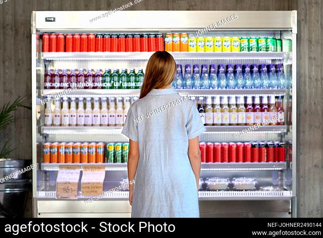 Woman standing in front of refrigerator in cafeteria
