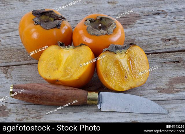 Japanese Japanese persimmon (Diospyros kaki) fruits and knife, Japanese persimmon, fruits and knife, Japanese persimmon, Japanese persimmon fig
