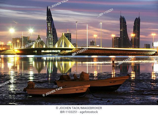 Skyline of the Corniche as seen from King Faisal Highway, Muharraq side, World Trade Center buildings, left, beside the towers of the Financial Harbour Complex
