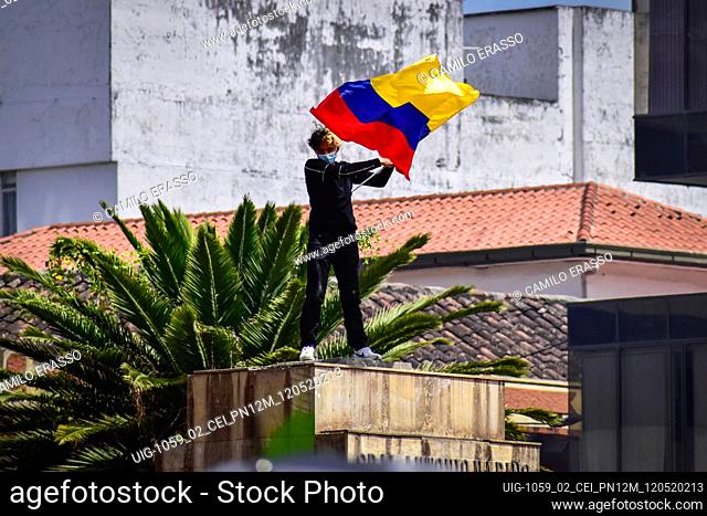 Demostrator waves the flag of Colombia at the place where the statue of Antonio Narino was located, that was removed the night before in the centre of the city...