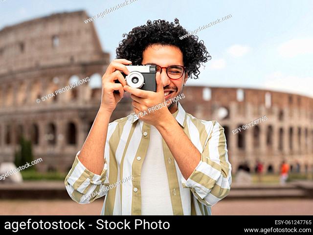 smiling man or photographer with camera in rome