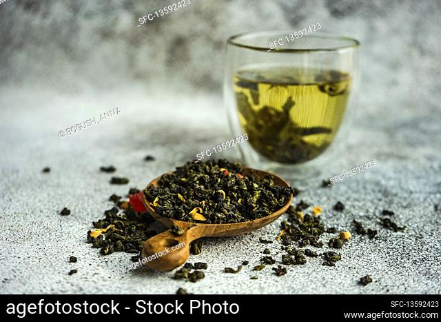 Green sencha tea leaves with pieces of mango