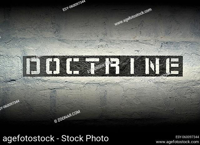 doctrine word stencil print on the grunge white brick wall