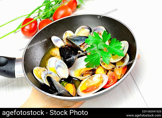saute seafood in a pan with olive oil and parsley