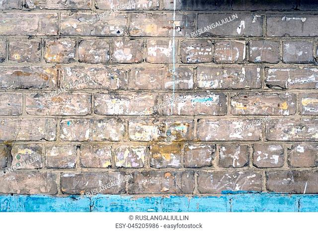 Abstract texture of old gray destroyed brick wall with plaster