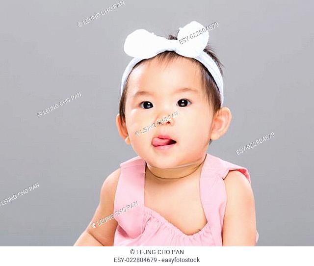 Asian baby girl show tongue
