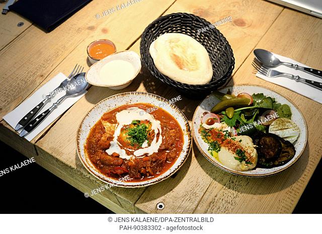 A traditional Israeli egg dish, ""Shakshuka"", can be seen laid out with side dishes at the Cafe ""Gordon"" in Neukoelln, Berlin, Germany, 3 May 2017