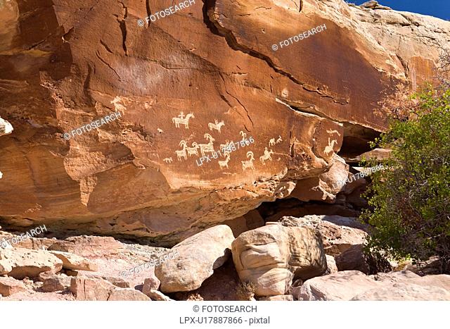 Petroglyphs etched into red rock, Arches National Park, Utah