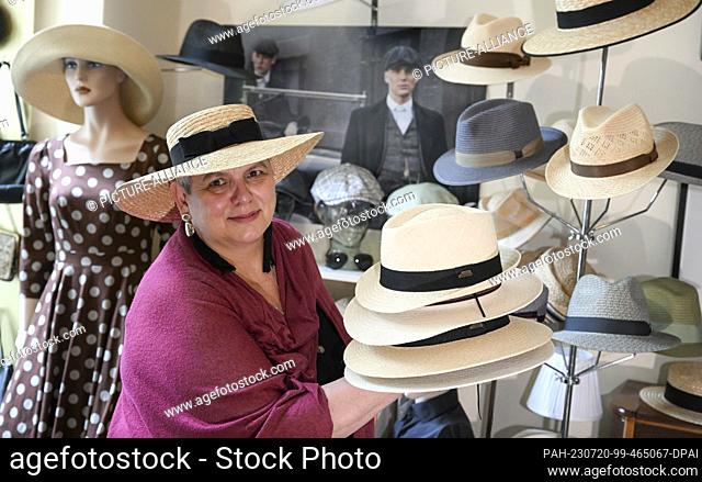 19 July 2023, Berlin: In her studio in the Günzelkiez in Wilmersdorf, milliner Petra Benz shows the Panama hats, which offer additional UV protection thanks to...