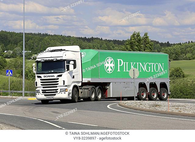 White Scania R560 truck and Pilkinton glass transport trailer on road intersection on a day of summer in Salo, Finland - June 2, 2018