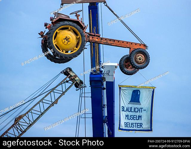 24 July 2020, Saxony-Anhalt, Beuster: An equipment carrier from GDR production, type RS09, hangs on a crane above the exhibition area during the blue light days...